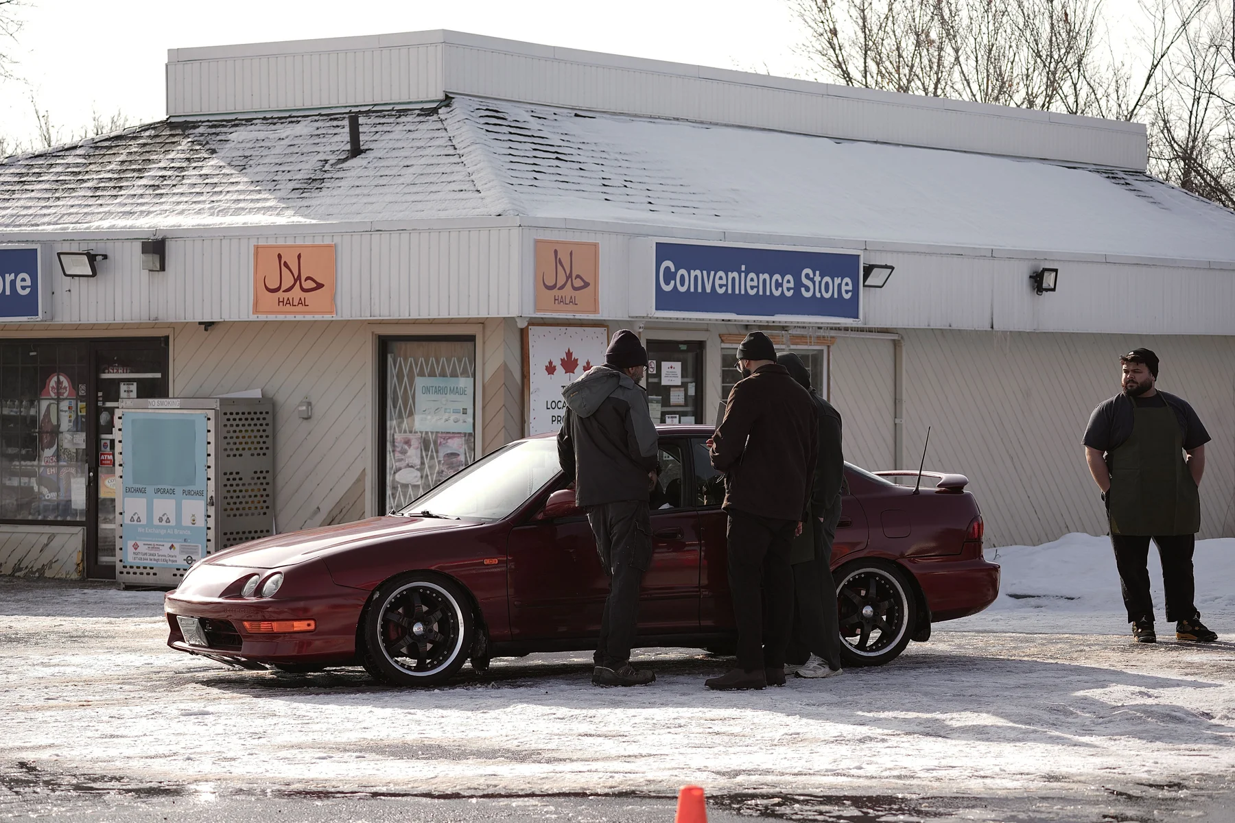 Crew beside the picture vehicle outside a convenience store during The Missing Dates production.