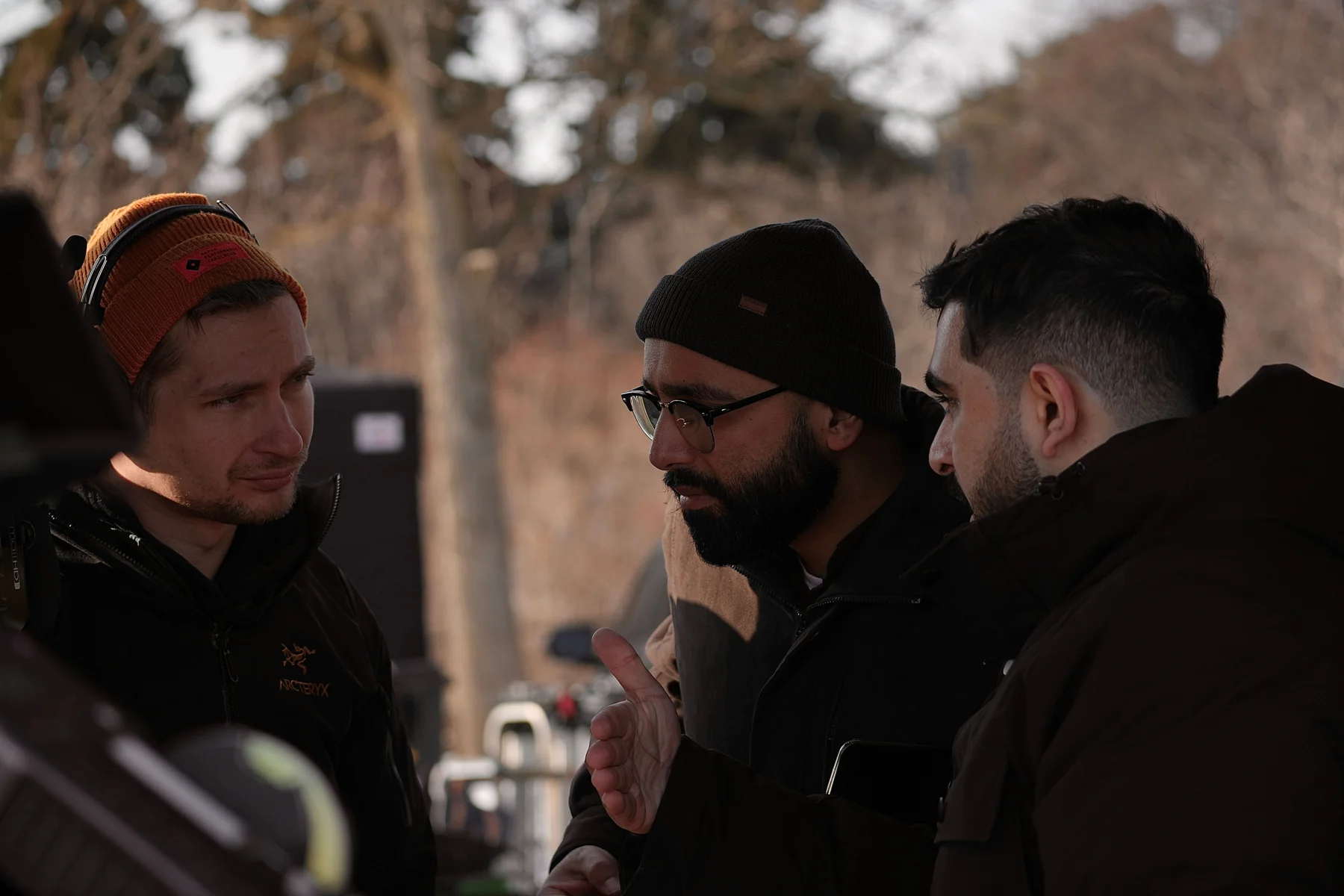 Crew members discuss the setup on the exterior set of The Missing Dates.